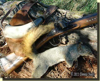 The Northwest gun, shot bag and horn beside the "missing squirrel."