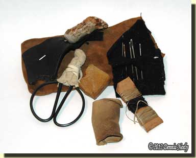 A woodland sewing kit kept in a small leather pouch.