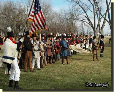 A line of militiamen stand at attention.