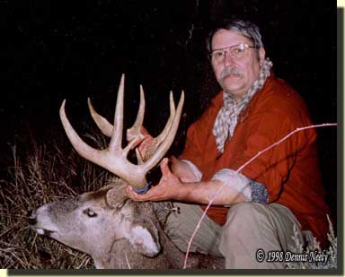 A traditional woodsman holding up a fine whitetail buck.
