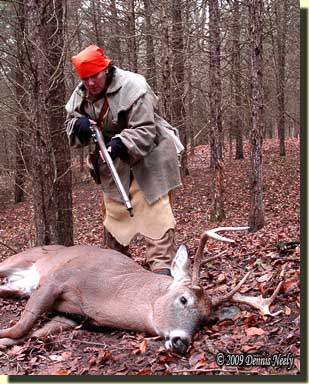 Tami Neely approaches a downed whitetail buck.