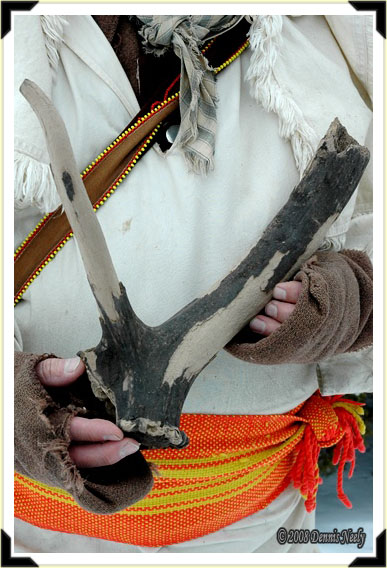 A traditional woodsman holding an elk antler.