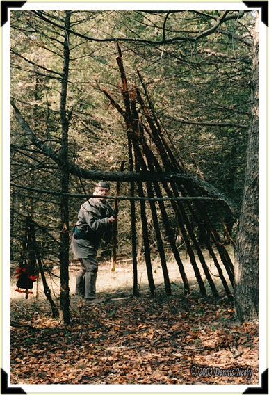 Traditional woodsman, Dennis Neely, places a cedar rafter on the duck camp.