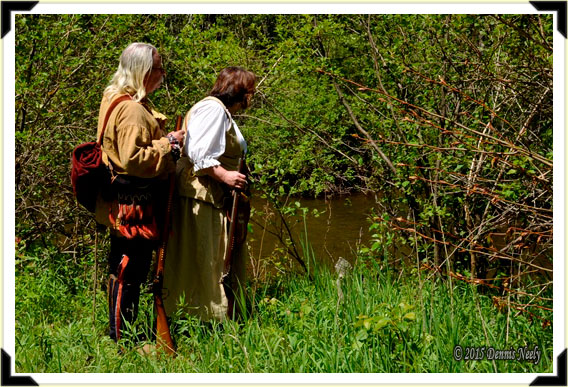 Living historians, Dennis and Tamara Neely, standing beside the Pigeon River.