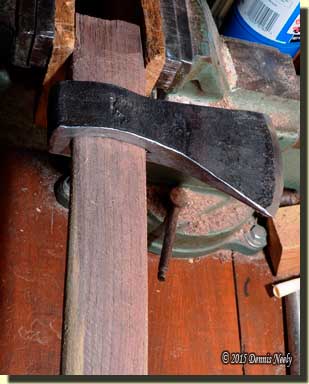 A trade ax head with a roughed-out handle.
