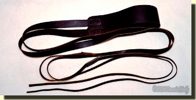 A leather portage collar coiled on a trade blanket.