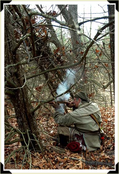 Traditional woodsman Dennis Neely firing Northwest gun at a wild turkey.