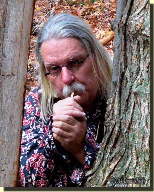 A traditional woodsman clucking on a single wing bone call.