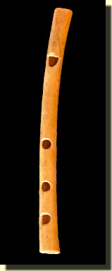 A three-hole Native American bone whistle or flute.