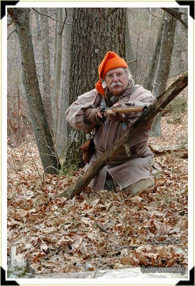 A traditional hunter raises his Northwest gun as the buck approaches.