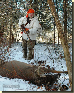 The post hunter walking up on a fine 8-point buck.